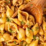 Wooden spoon scooping up one pot taco pasta.