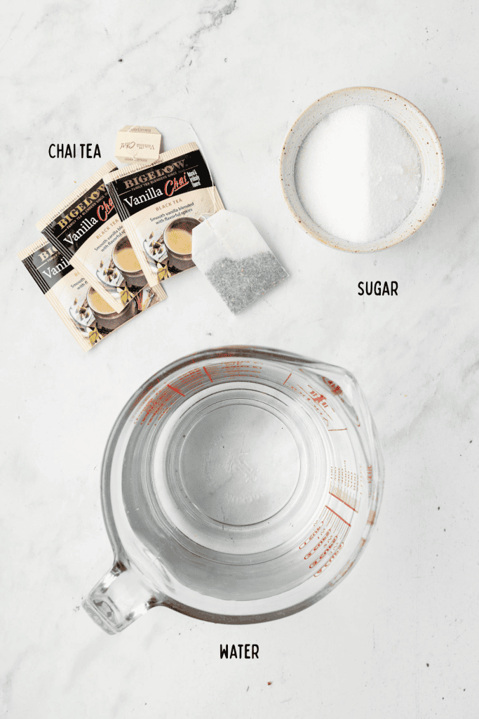 Water, chai tea packets, and sugar