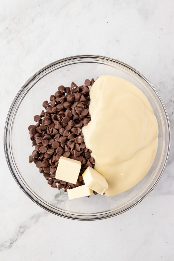Chocolate chips, sweet condensed milk, butter, and a mixing bowl
