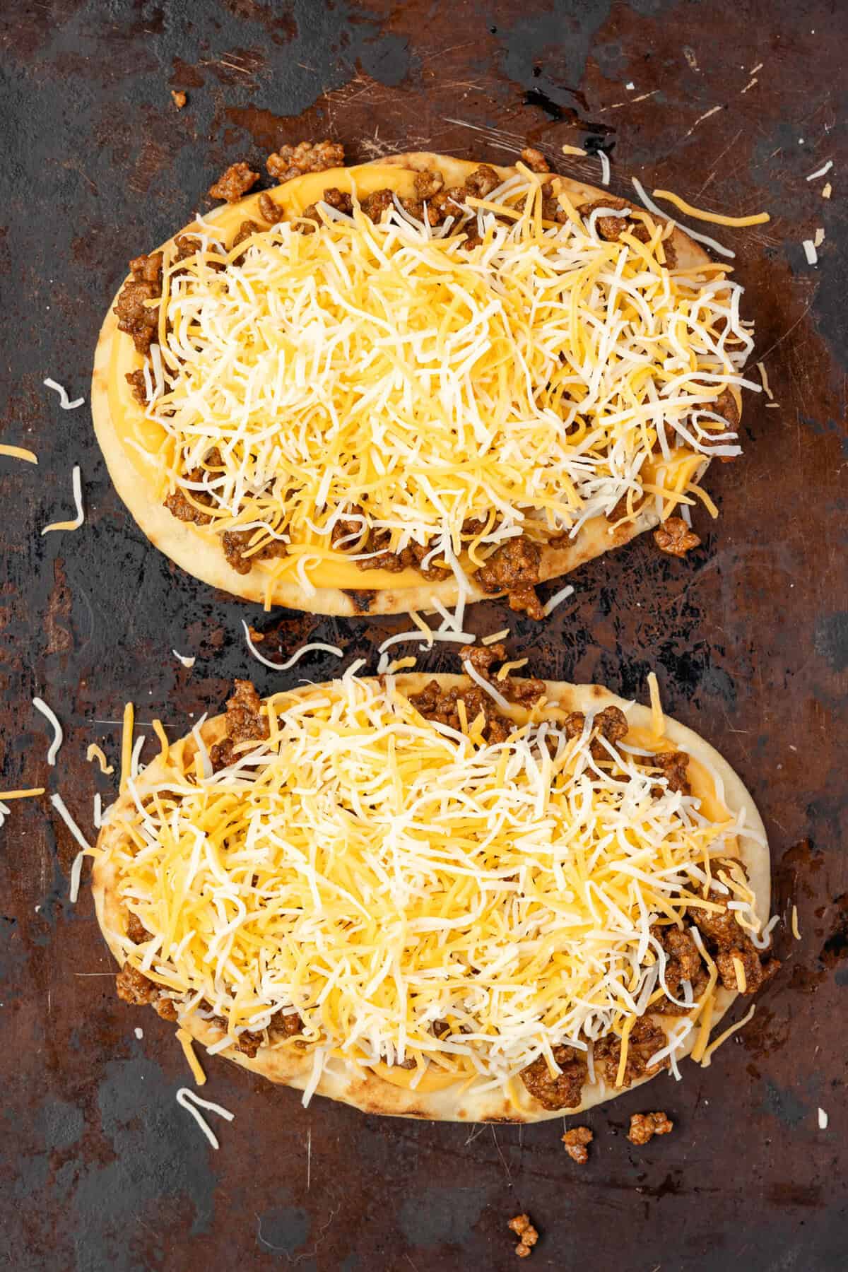 cheese topped taco pizza on sheet pan.