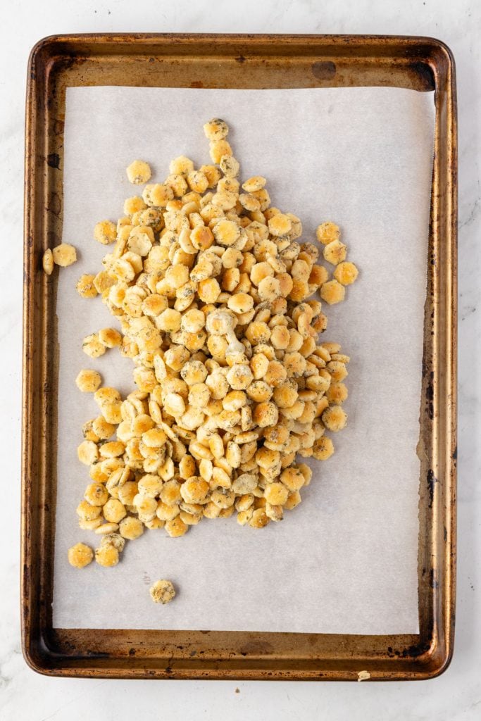 Ranch dill oyster crackers dumped onto a sheet pan