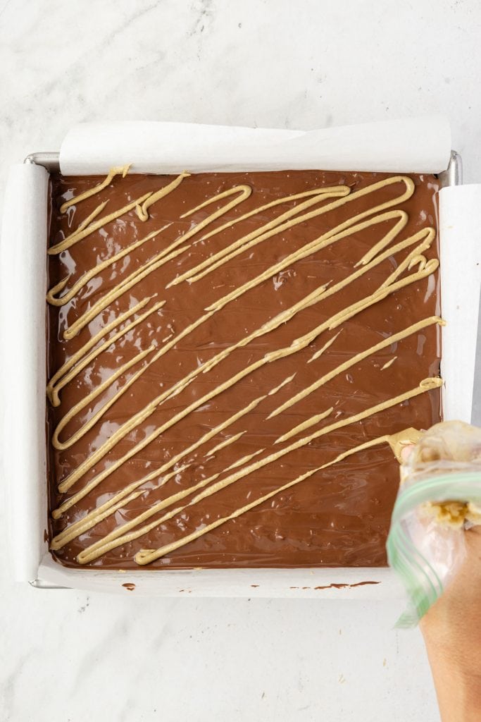 Drizzling pistachio butter over Dubai Brownies