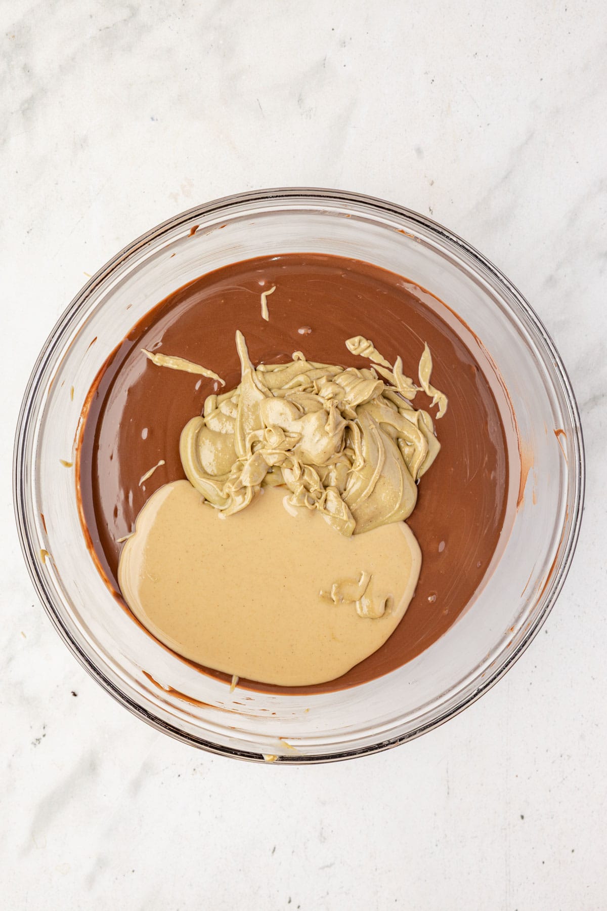 Pistachio butter, sesame paste, and chocolate in a mixing bowl.