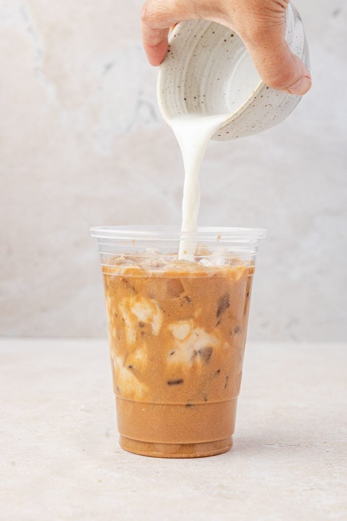Pouring the milk into a pumpkin latte