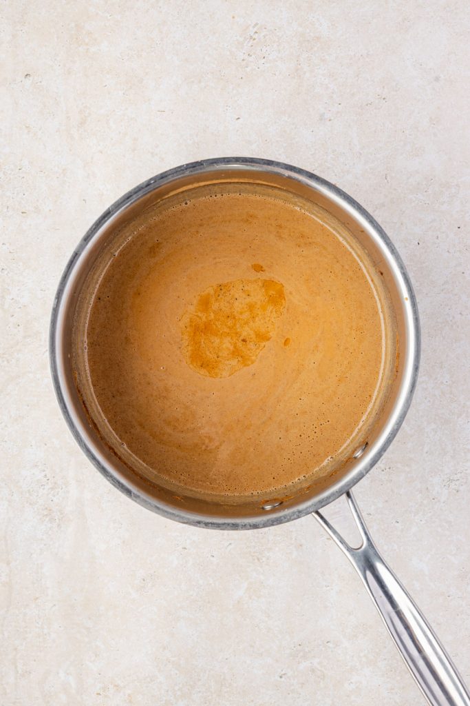 Vanilla added to pumpkin sauce in a pot