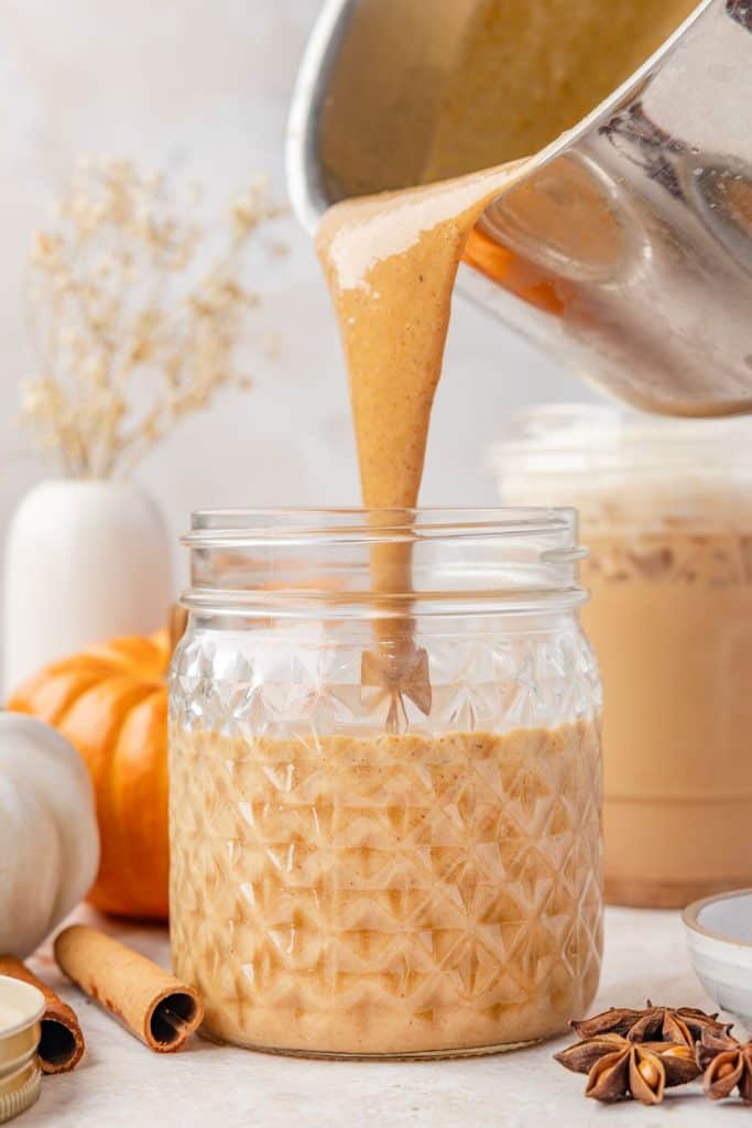 Pumpkin sauce being poured into a mason jar