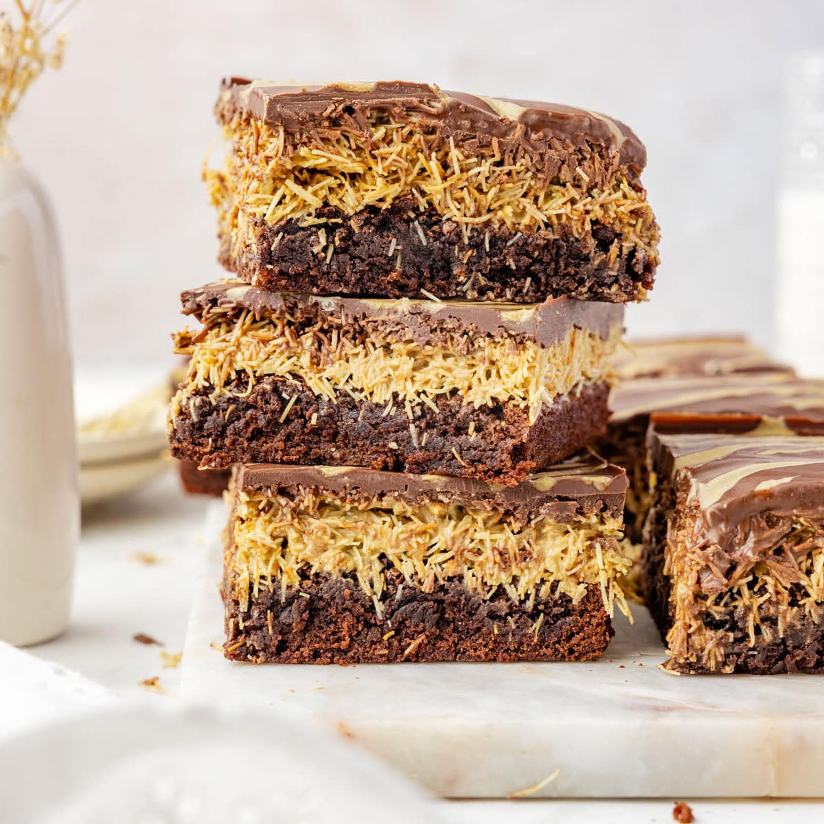 three Dubai Brownies stacked on a piece of marble