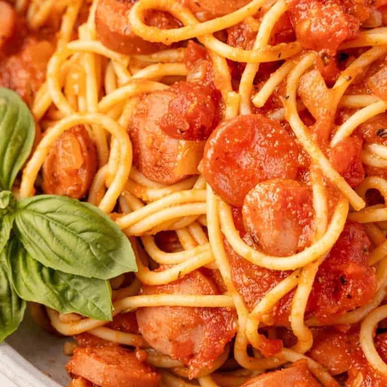close up of Spaghetti and Hot Dogs with basil