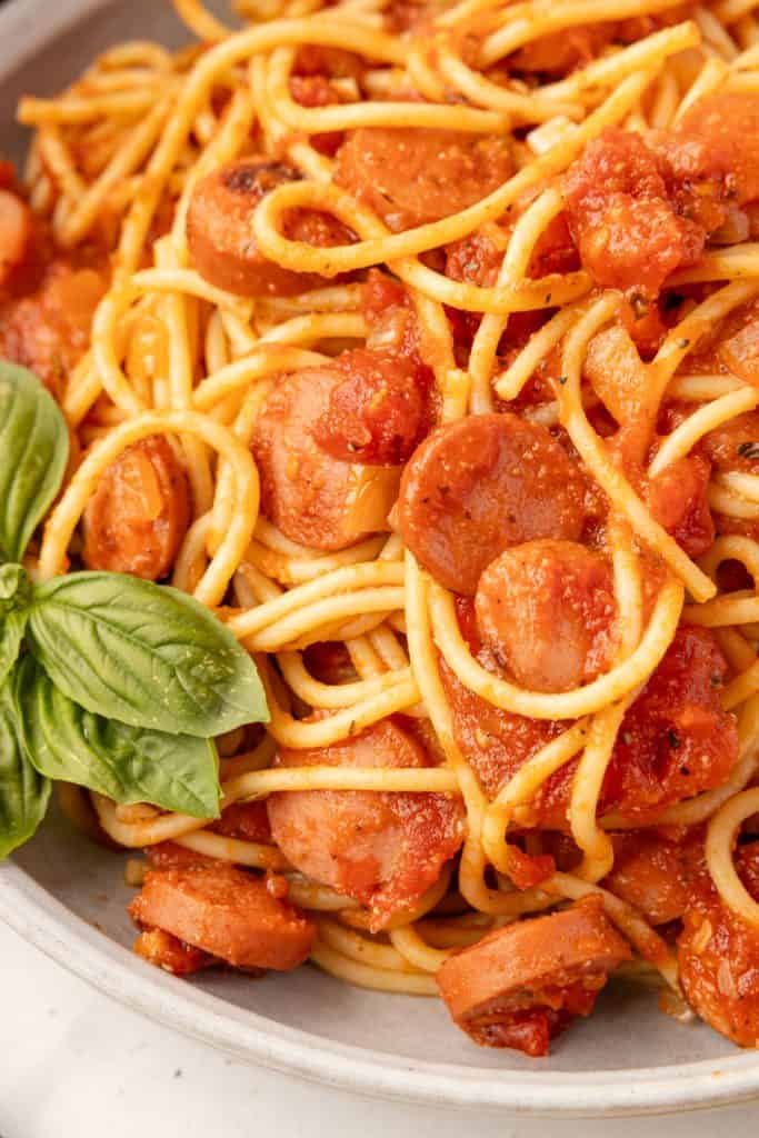 Spaghetti and Hot DogsWeb020 close up of Spaghetti and Hot Dogs with basil.