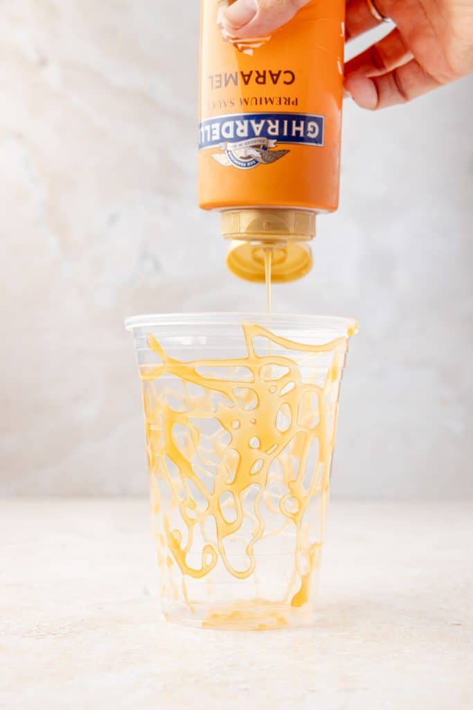 drizzling the caramel into cup