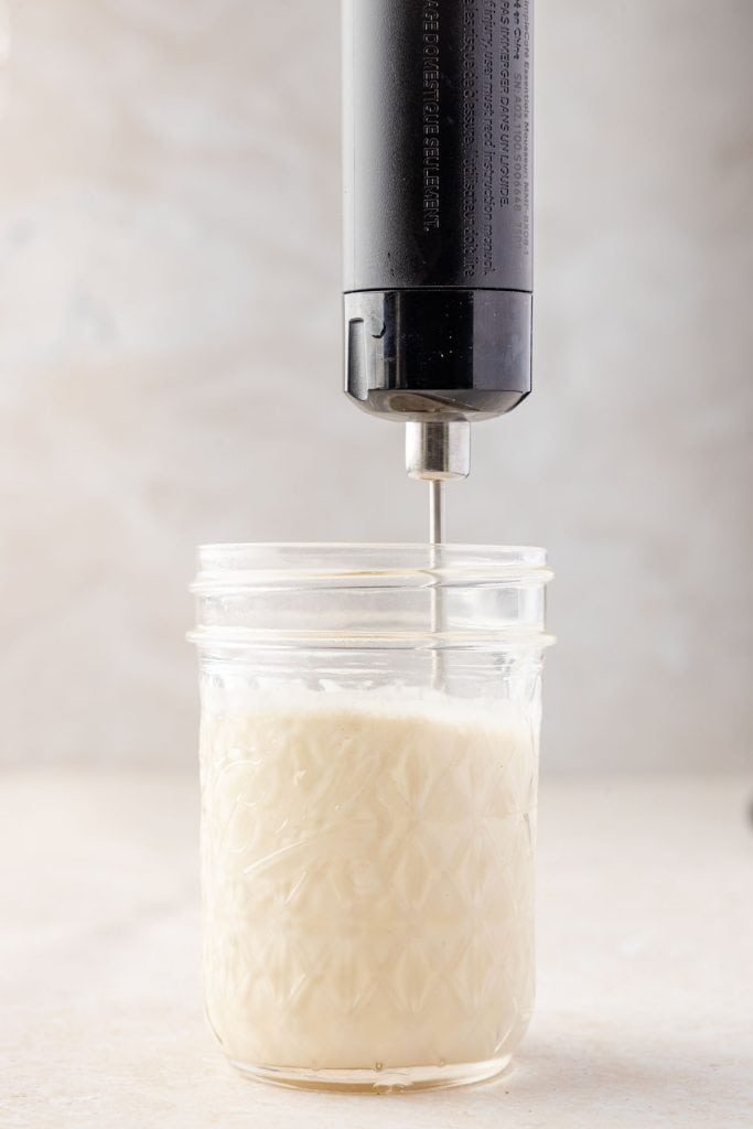 Cold foam being whipped up in a cup
