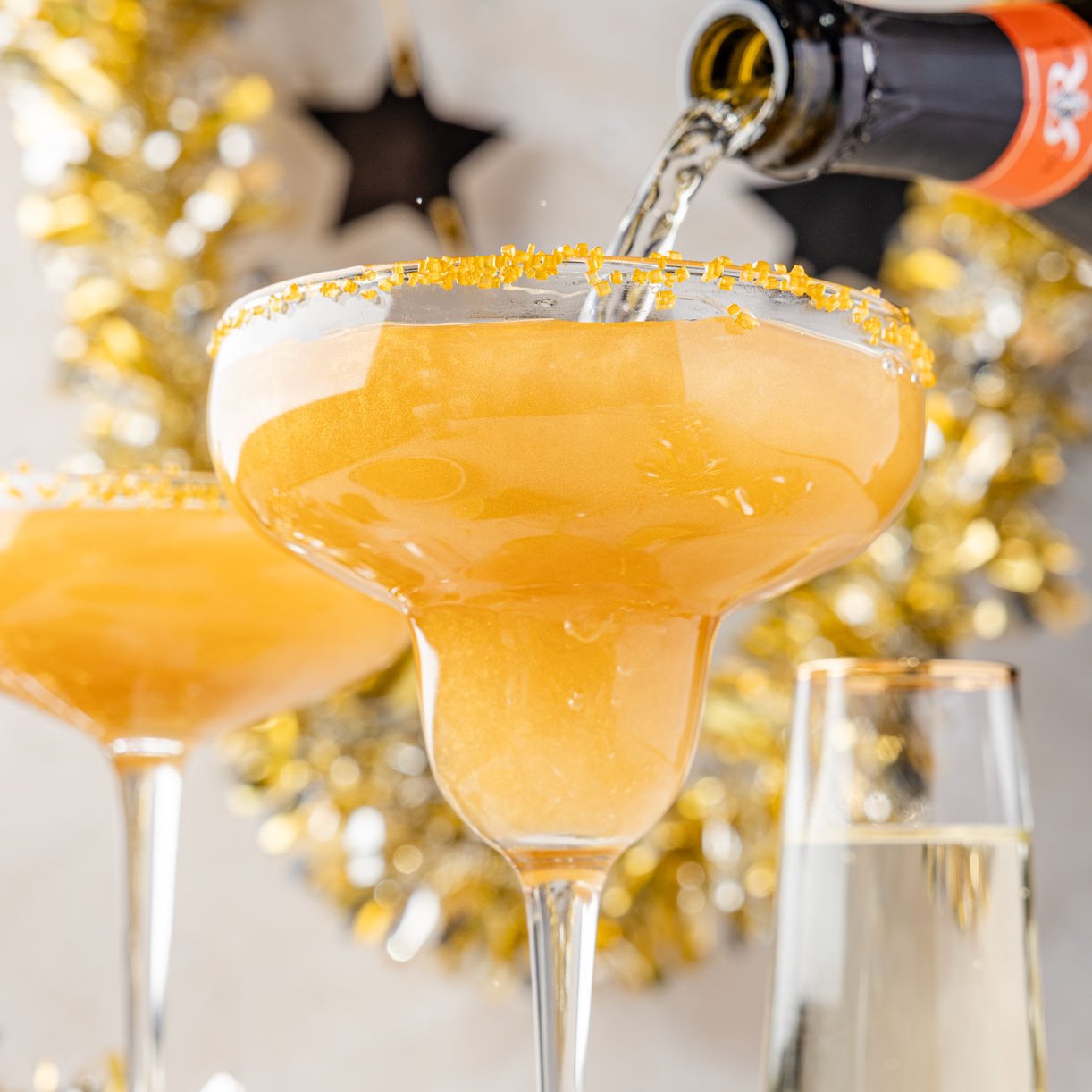 Two glasses of champagne margarita with a fun New Year's