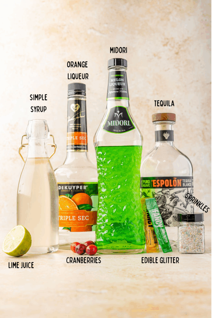 Simple syrup, orange Lacore, Midori, tequila, edible, glitter, sprinkles, cranberries, lime, set up for ingredient shop for grinch. Margarita.