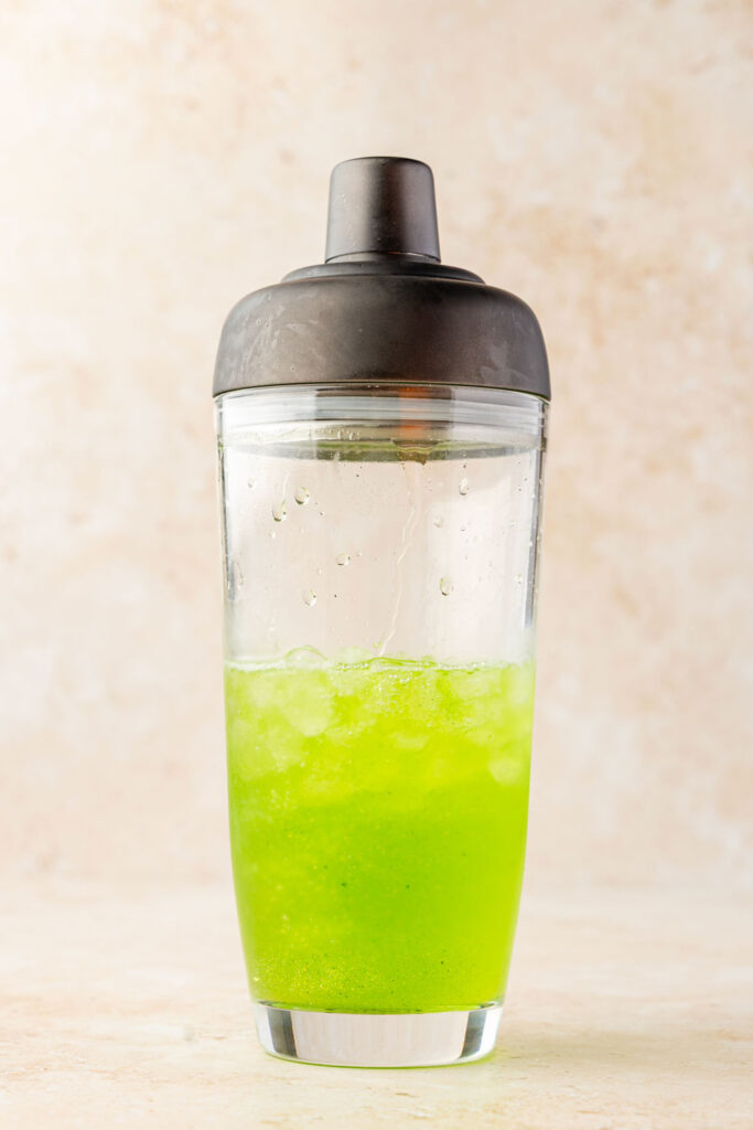 Grinch margarita in a cocktail shaker