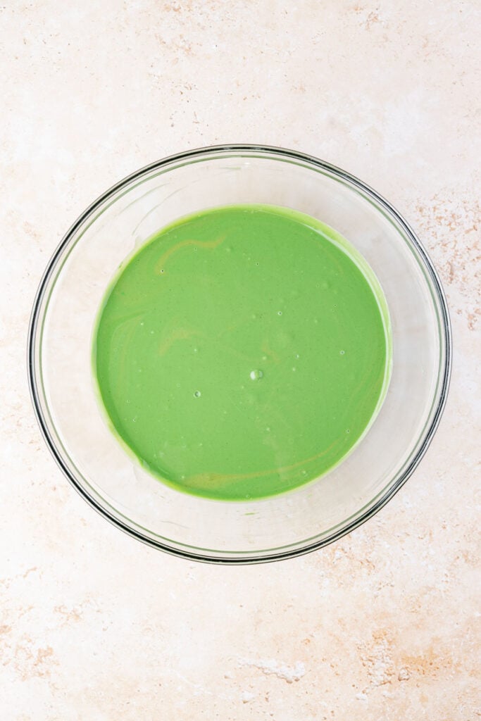 melted green white chocolate, butter, and peanut butter in a mixing bowl