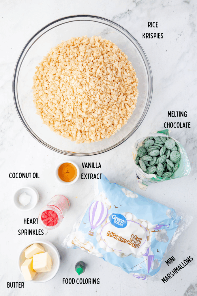 Ingredients for grinch rice, crispy treats in a small individual bowls and a large bowl for the rice crispies