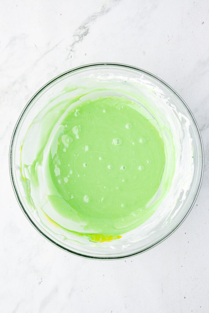 Melted marshmallow and food coloring in a mixing bowl