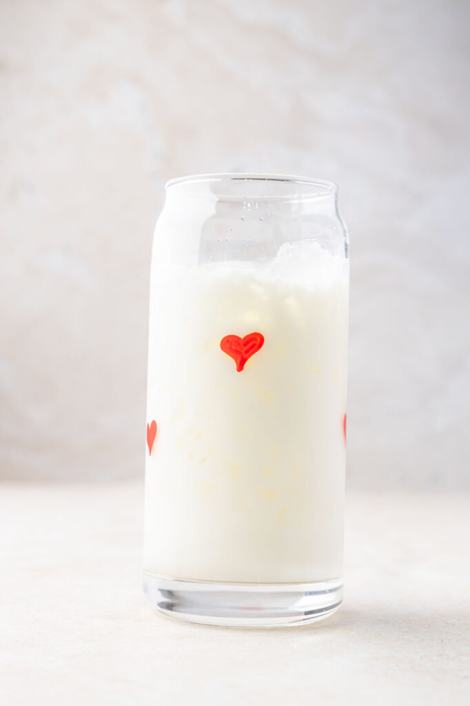 Ice and milk in a cup with hearts on it