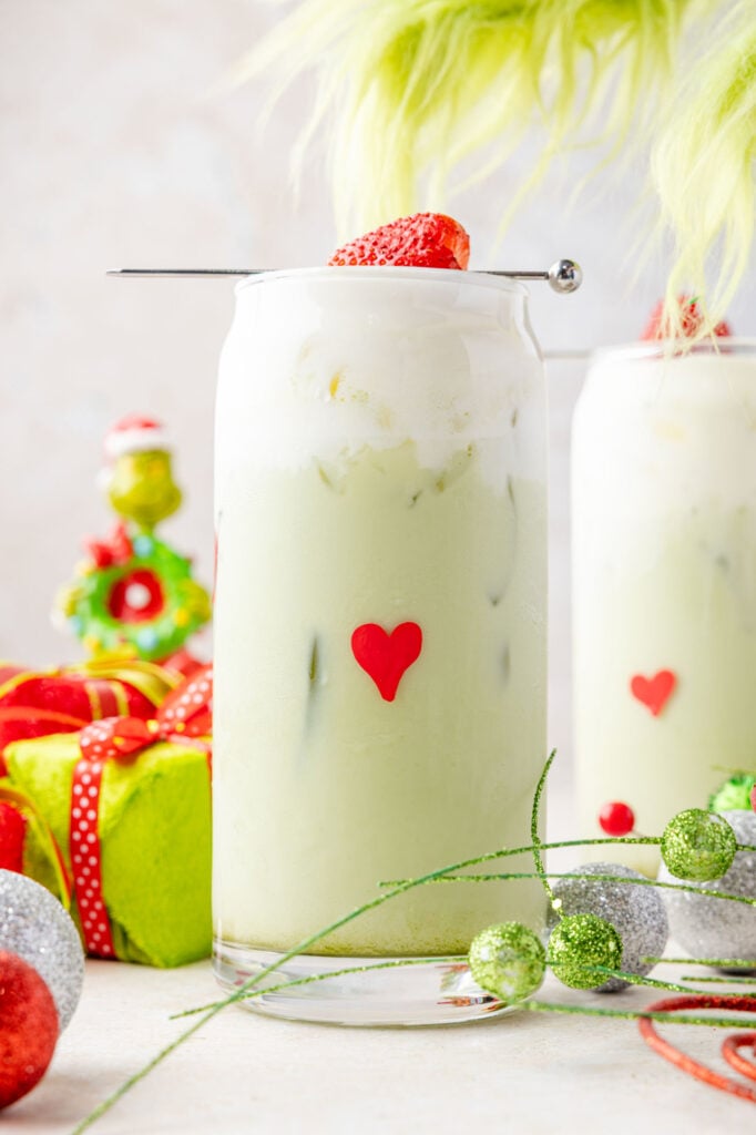 Iced Matcha latte with the Grinch hand coming to steal it