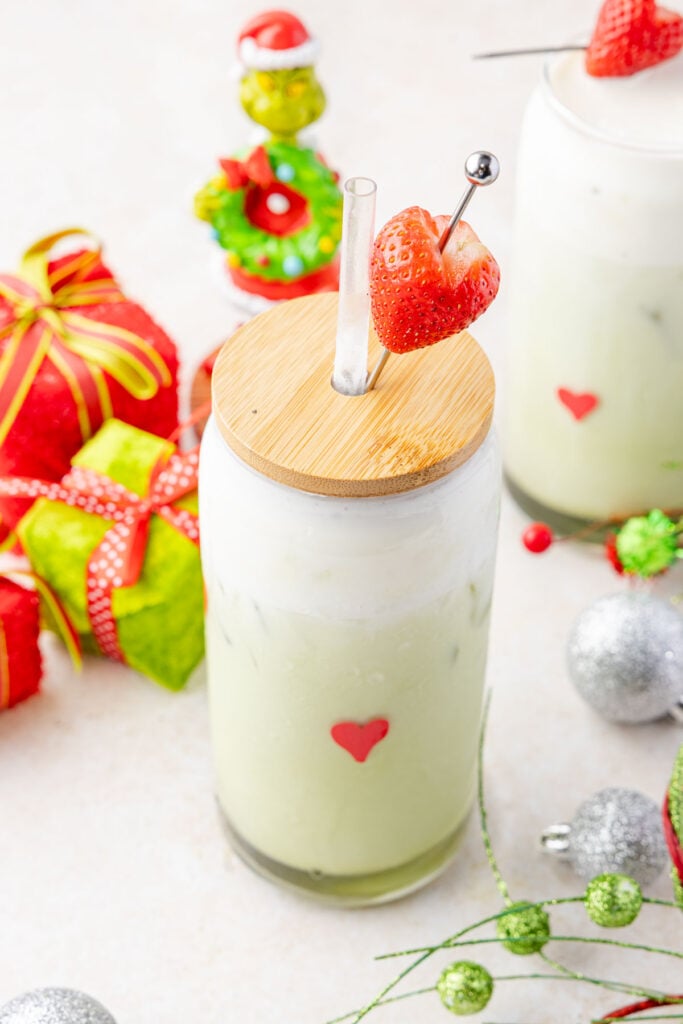 Close-up of iced grinch latte with grinch decorations