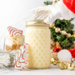 Santa arm grabbing a mason jar of Little Debbie Christmas Tree Coffee Creamer