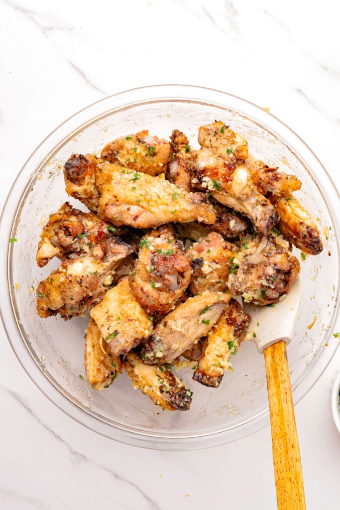 Finished Air Fryer Garlic Parmesan Wings in a mixing bowl