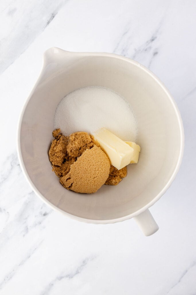 Butter, brown sugar, granulated sugar, and a mixing bowl.