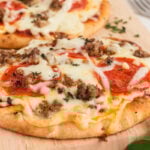 naan flatbread pizza on a cutting board