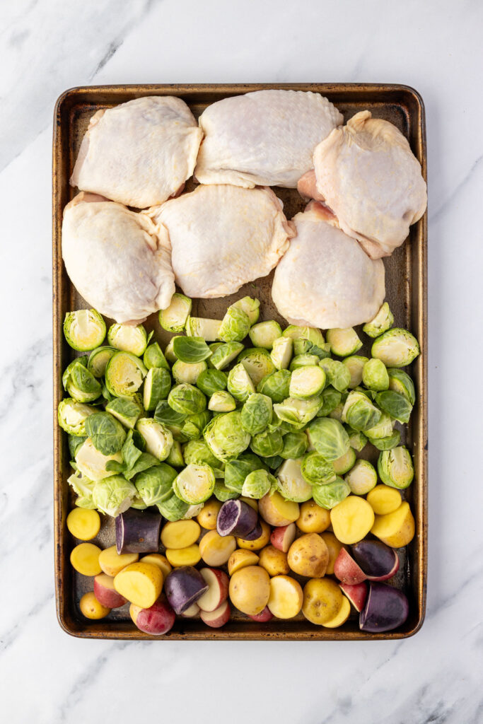 Chicken thighs, Brussel sprouts and potatoes on a sheet pan