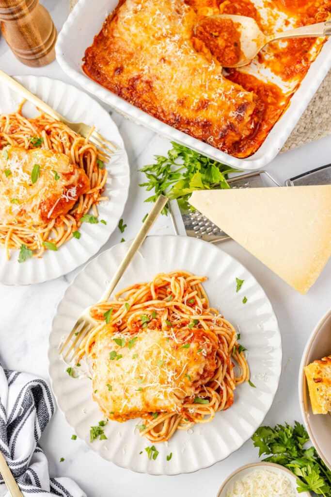 Plated Chicken Parmesan With Chicken Strips on spaghetti on plate plates