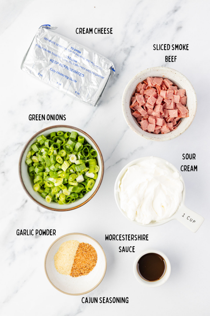 Ingredients Chipped Beef Dip an individual mixing bowls on a marble surface.