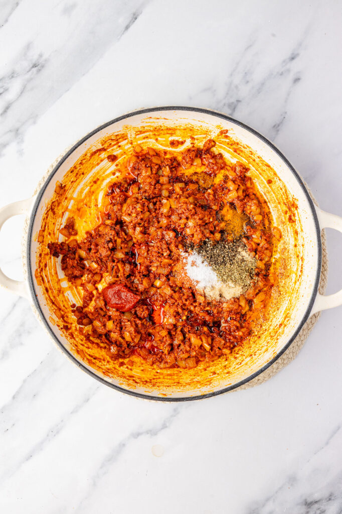 Cooked chorizo and onions in a pan with spices