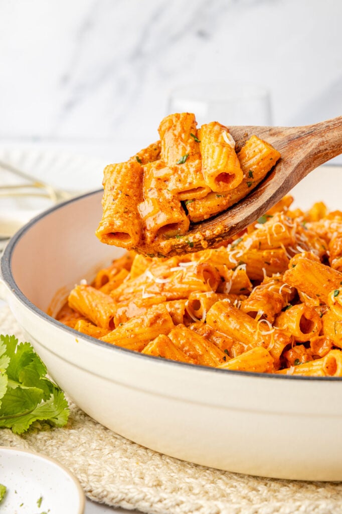Creamy Chorizo Pasta being scooped up with a wooden spoon