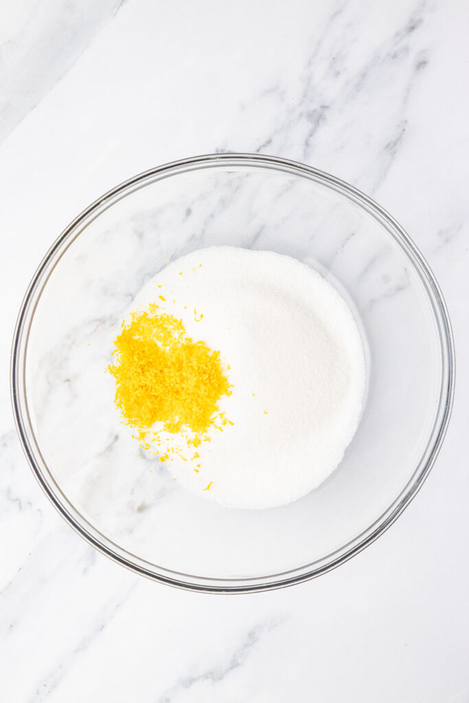 Sugar and lemon zest in a mixing bowl