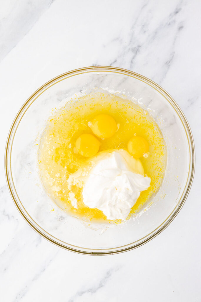 Eggs and sour cream in a mixing bowl