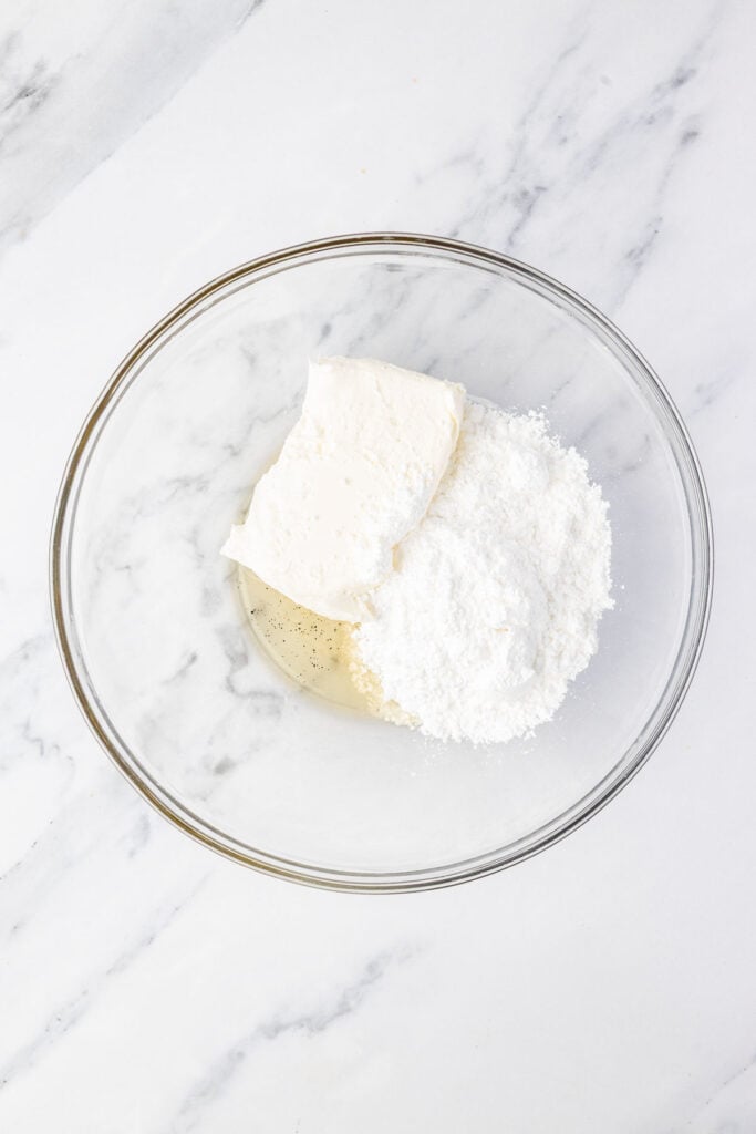 cream cheese and powdered sugar in a mixing bowl
