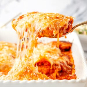 Chicken Parmesan With Chicken Strips being scooped up with a cheese pull