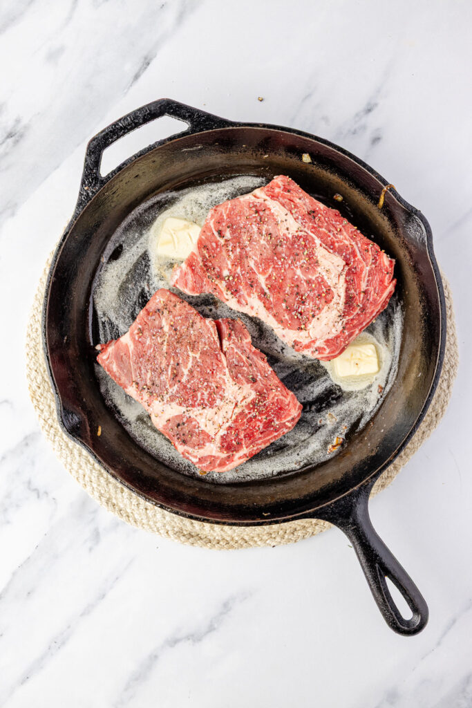 Steak in a cast-iron pan with butter