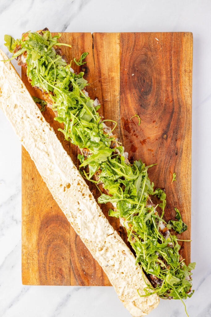 Steak sandwich on a cutting board open