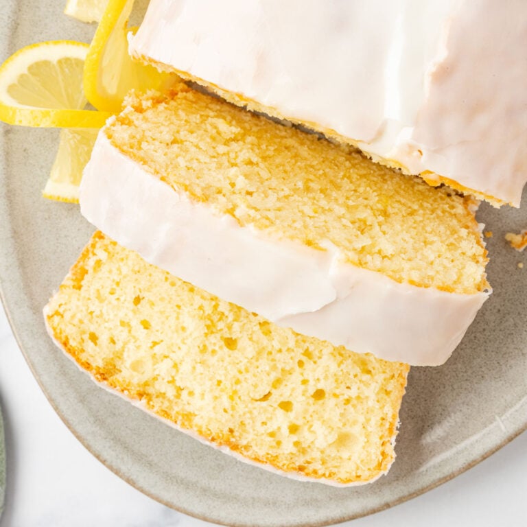 Up close image of Copycat Starbucks Lemon Loaf on a platter with lemon slices