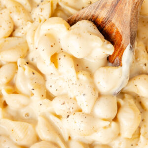 Wooden spoon scooping Smoked Gouda Mac and Cheese