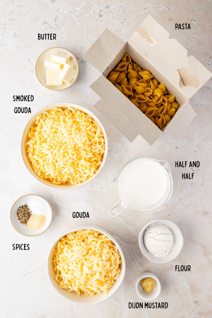 Ingredients for Smoked Gouda Mac and Cheese an individual, small bowls, and a box of shell pasta
