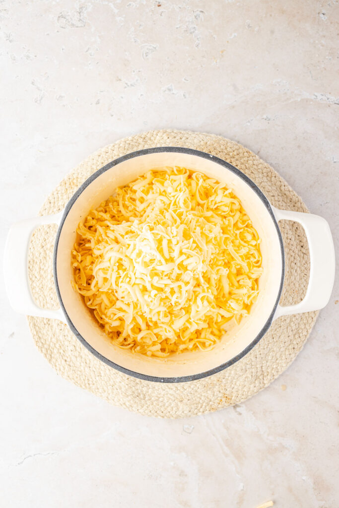 Lots of cheese being shown in a pot