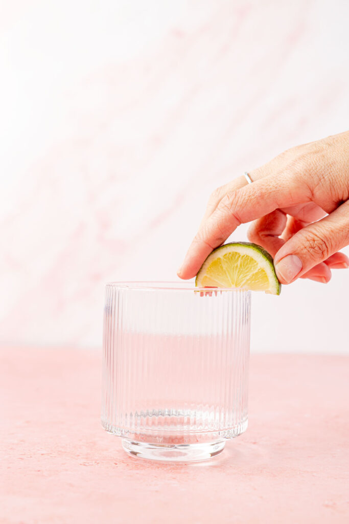 Lime being rubbed around edge of glass