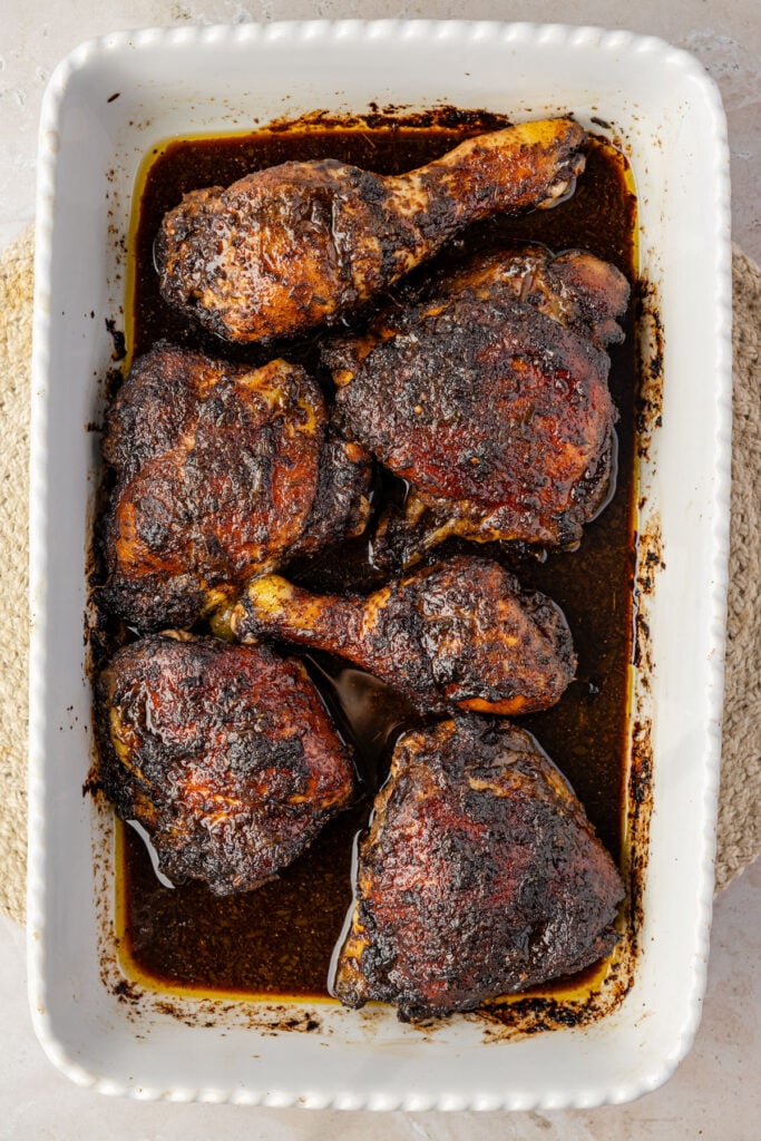 Close-up of baked jerk chicken in a casserole pan