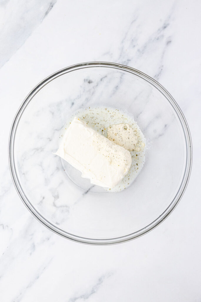 Cream cheese and ranch dressing in a mixing bowl