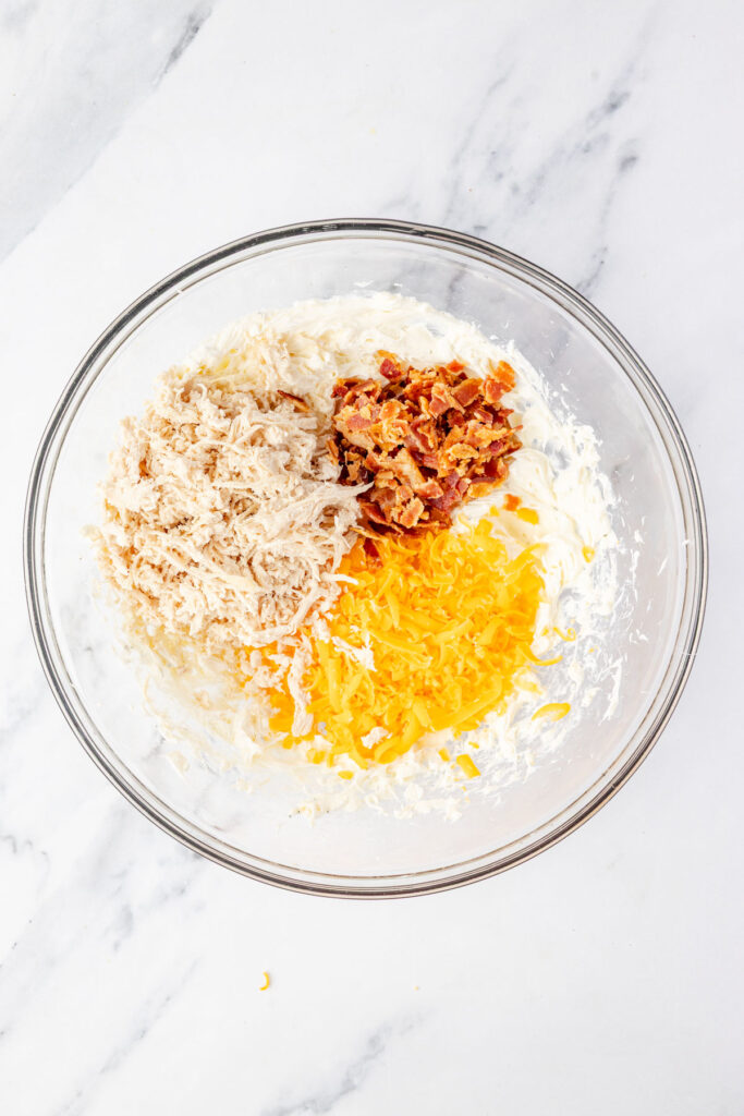 Soften cream cheese mixture, chicken, bacon, cheese in a mixing bowl
