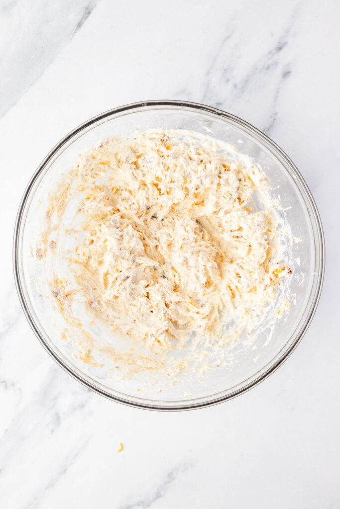 Cracked chicken pinwheel filling in a mixing bowl