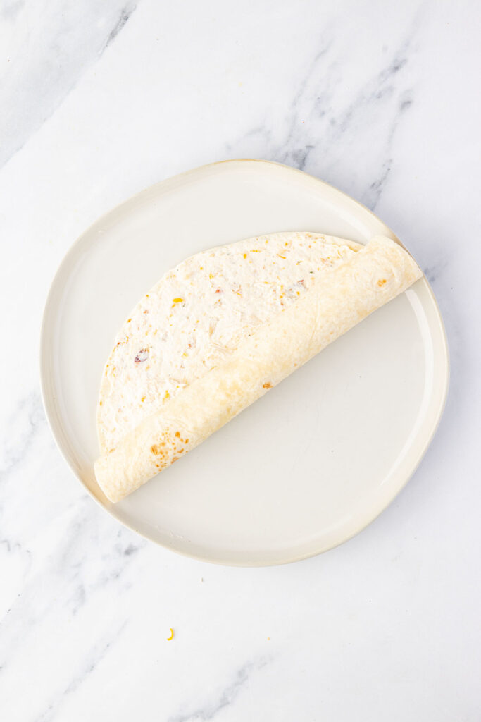 Rolling up a pinwheel on a plate