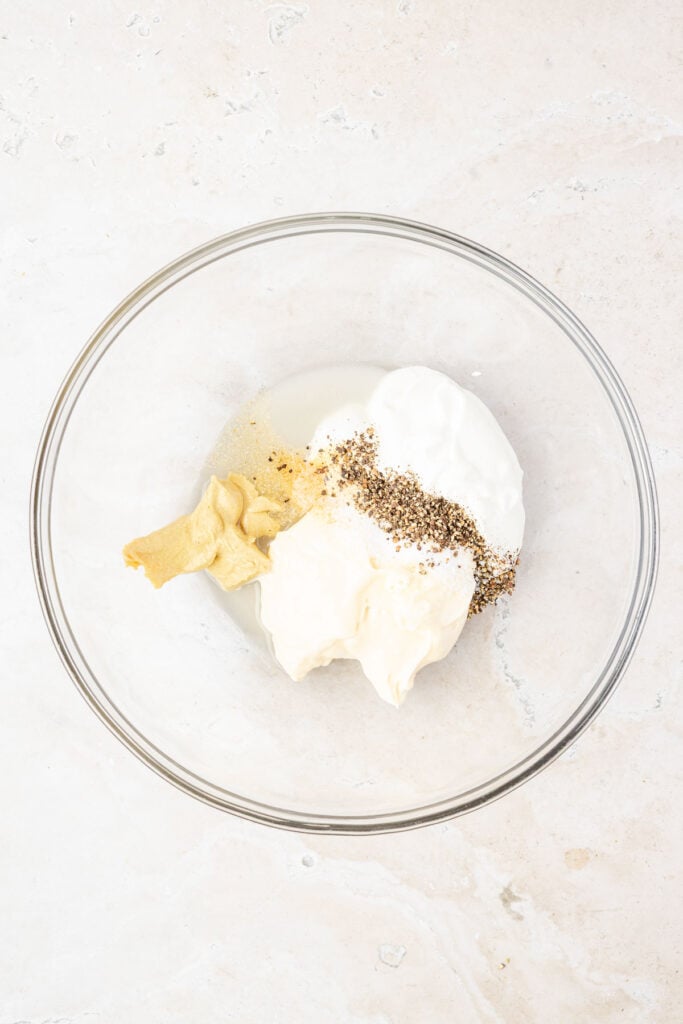 Mustard sugar mayonnaise Greek yogurt in a mixing bowl